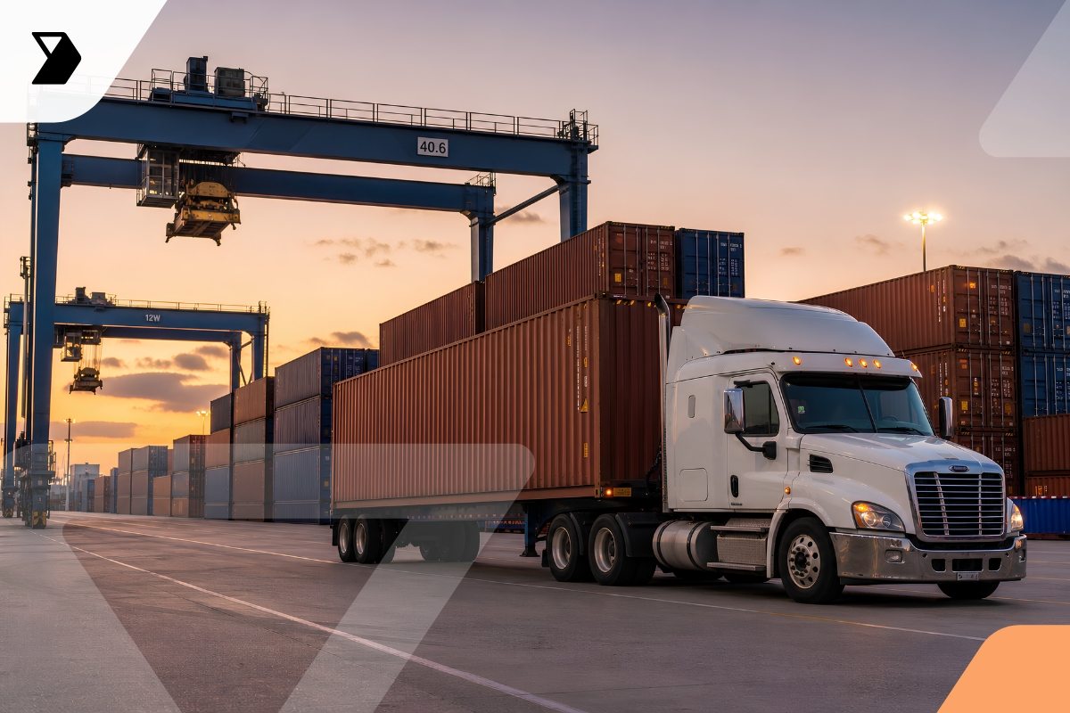 A white semi-truck with a container trailer is parked at a shipping yard during sunset, surrounded by stacked cargo containers and large cranes.