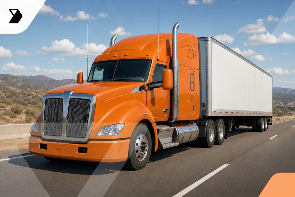 An orange semi-truck with a white trailer drives on a highway through a desert landscape, illustrating fleet operations—what does fleet operations mean?