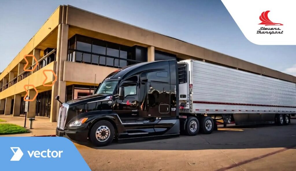 A black semi-truck with a white trailer is parked outside a beige office building. The Stevens Transport logo is in the top right corner, and a blue banner with vector to Enhance Fleet Operations appears in the bottom left corner.